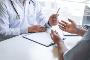 Doctor and patient discussing symptoms during a consultation.